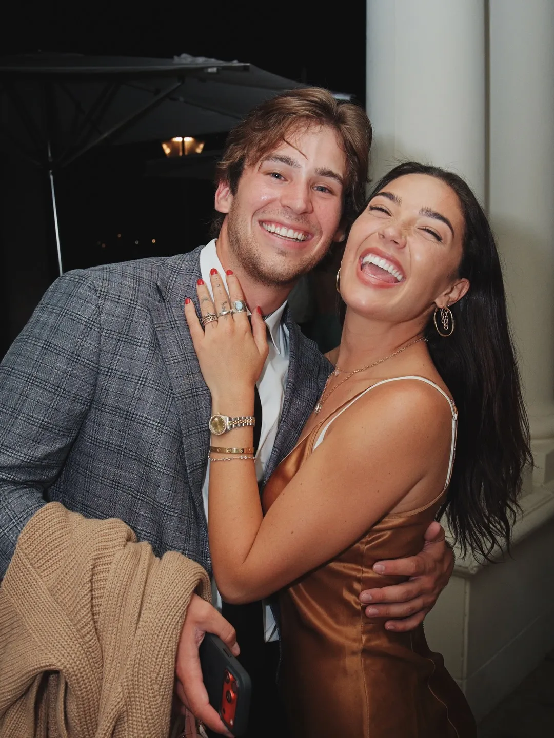 Couple laughing together at their wedding reception