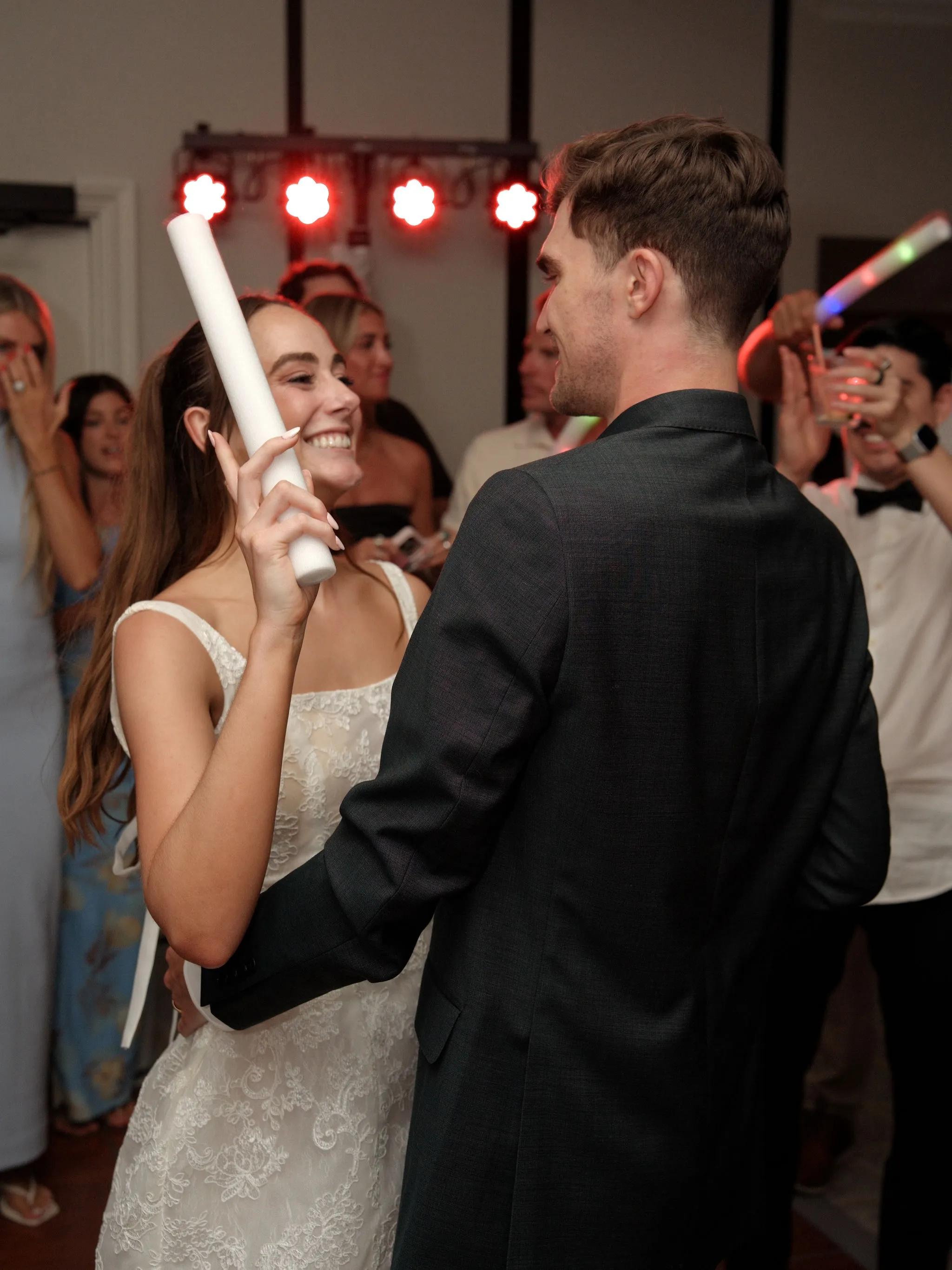 First dance at a wedding reception under warm string lights