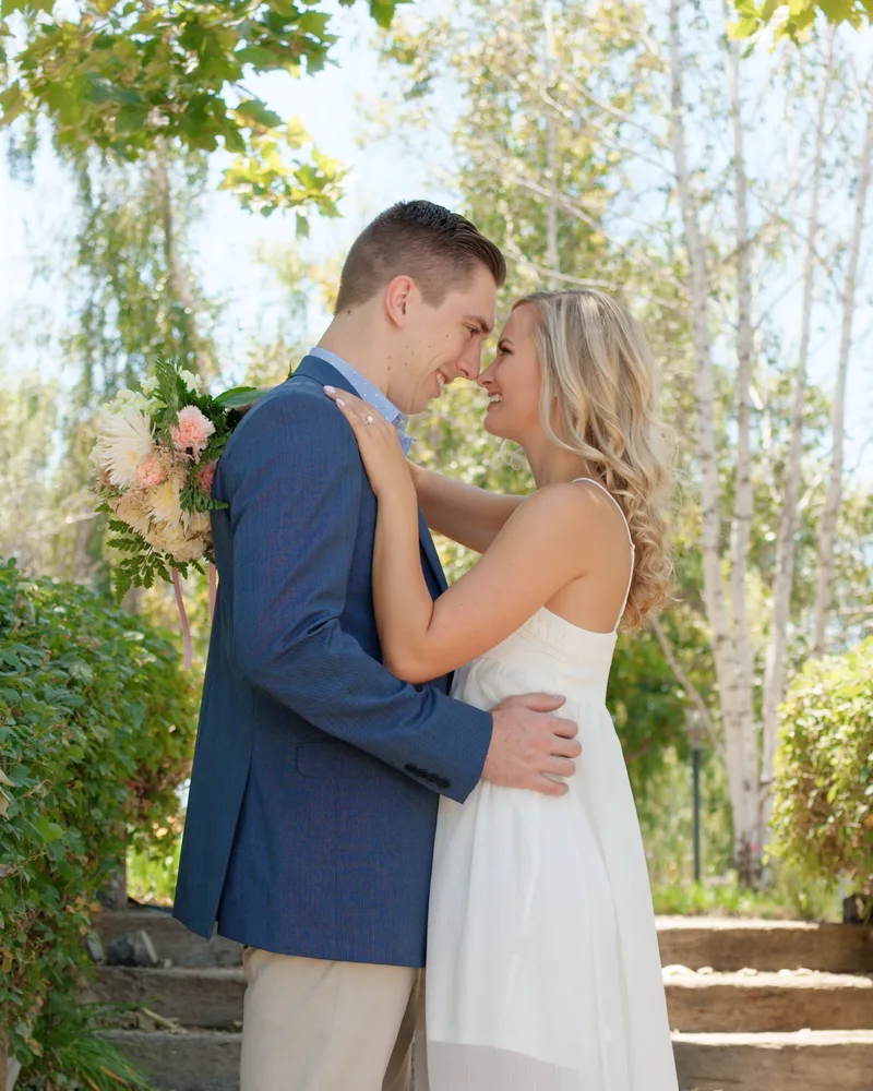 Robby and Kelly embracing in a garden — engagement session
