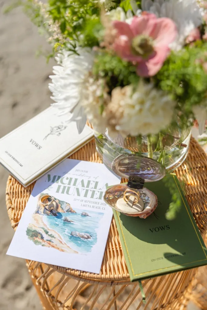 The suite in situ — rings, vow books, and sea air