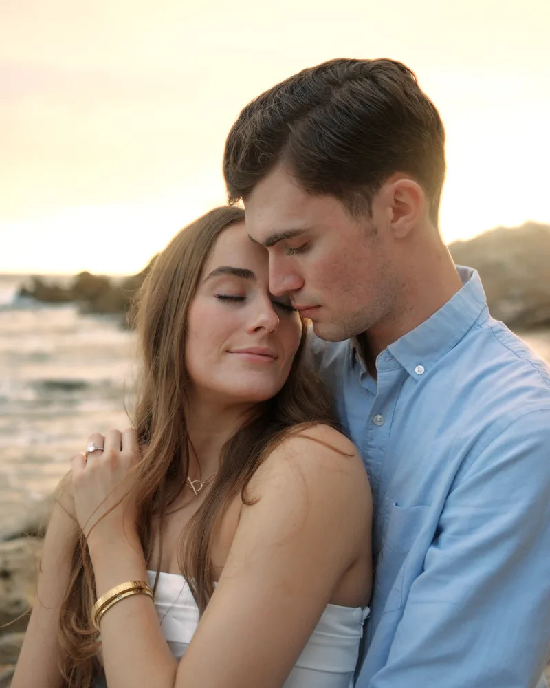 Couple embracing at sunset on the beach — engagement session