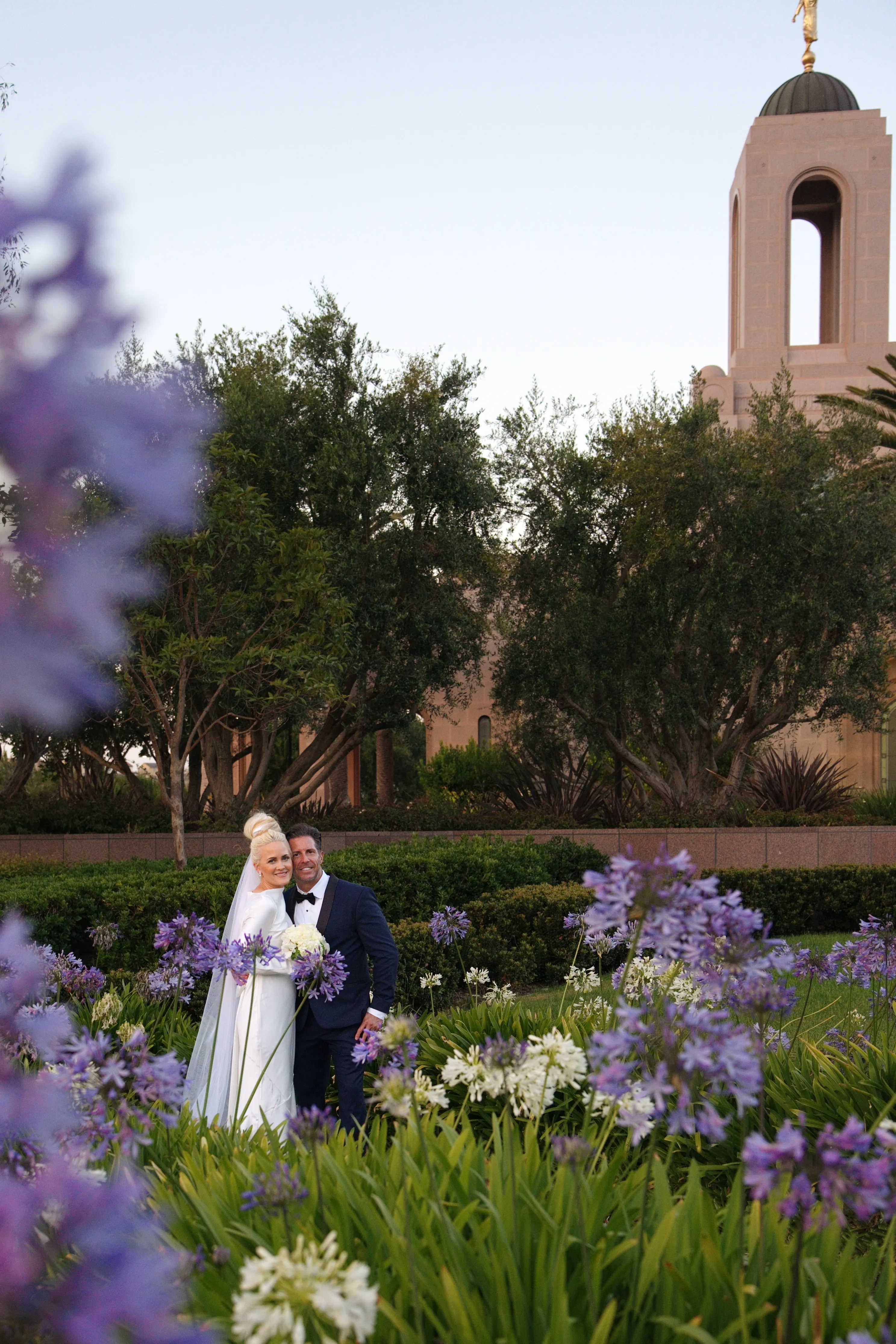Couple walking through the temple gardens after their ceremony
